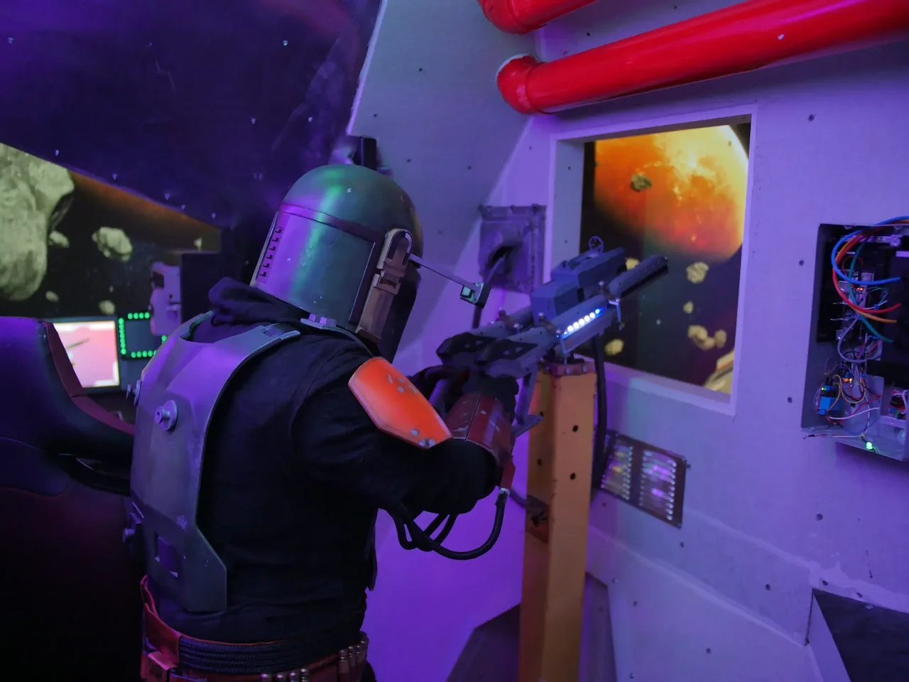 A player in Mandalorian armor inside the Odyssey Augmented room
